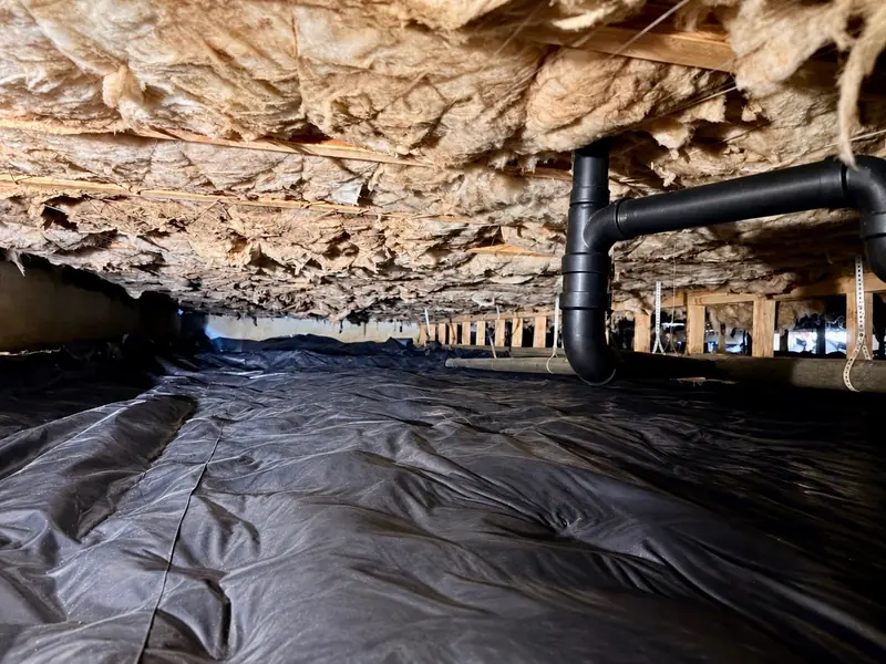 Finished crawl space with a new black barrier